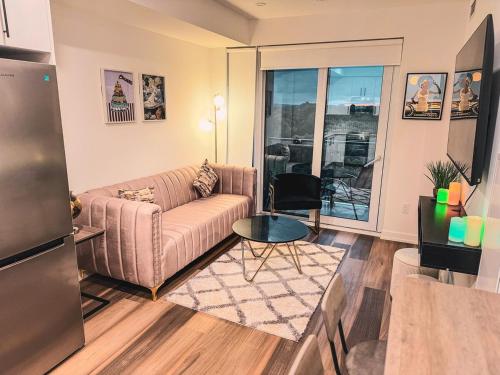 a living room with a couch and a table at LuxCondo in the Downtown Kitchener Uptown Waterloo in Kitchener