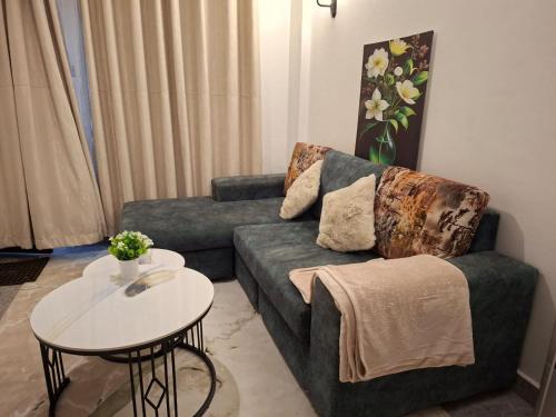 a living room with a couch and a table at Ben's Apartment - Near Ngong Karen in Nairobi