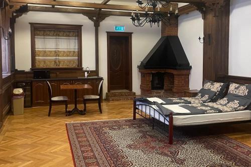 a living room with a couch and a fireplace at Reneszánsz Vendégház in Debrecen