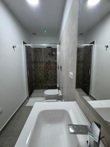 a bathroom with a white tub and a toilet at Civico17room in Cirò Marina