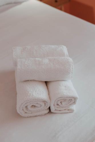 a pile of towels sitting on top of a sink at Cozy Peach Nest in Tolo