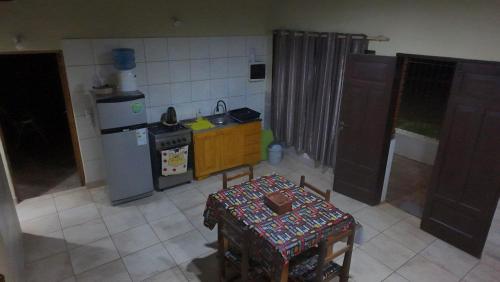 a small kitchen with a stove and a table in it at La Reina in Eldorado