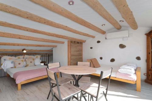 a bedroom with a bed and a table and chairs at Marina Vila House, Vista Playa in El Masnou