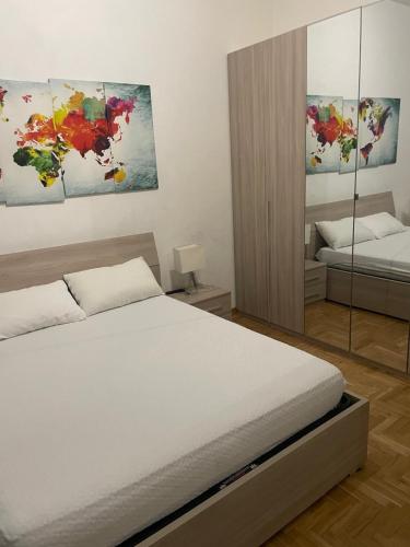 a bedroom with a bed and a painting on the wall at Vista Vittorio Veneto in Follonica