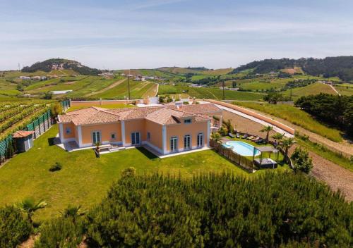 an aerial view of a house in a vineyard at VILLA ALTUS near Ericeira with swimming pool, jacuzzi and 2 games room in Cambaia