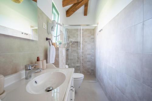 a bathroom with a sink and a toilet and a shower at Villa Kaia in Kringa