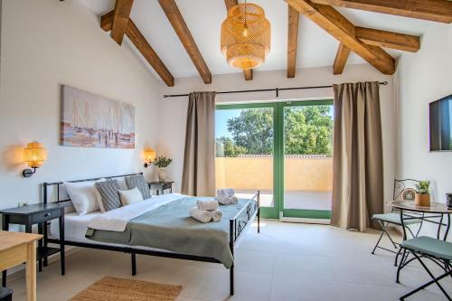 a bedroom with a bed and a large window at Villa Kaia in Kringa