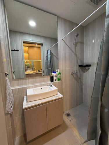 a bathroom with a sink and a shower at Apartment Bella Pakuwon City Mall Surabaya 3 pax in Surabaya