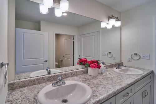 a bathroom with two sinks and a large mirror at The Ruby 301 By Avada Properties in Pigeon Forge