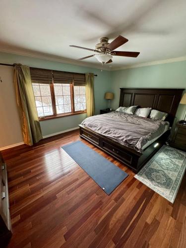 a bedroom with a bed and a ceiling fan at Cozy & Spacious Michigan Retreat in Livonia