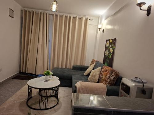 a living room with a couch and a table at Ben's Apartment - Near Ngong Karen in Nairobi