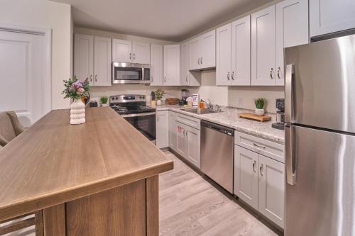 a kitchen with white cabinets and a stainless steel refrigerator at The Ruby 303 By Avada Properties in Pigeon Forge