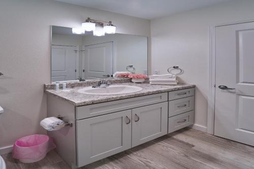 a bathroom with a sink and a large mirror at The Ruby 303 By Avada Properties in Pigeon Forge
