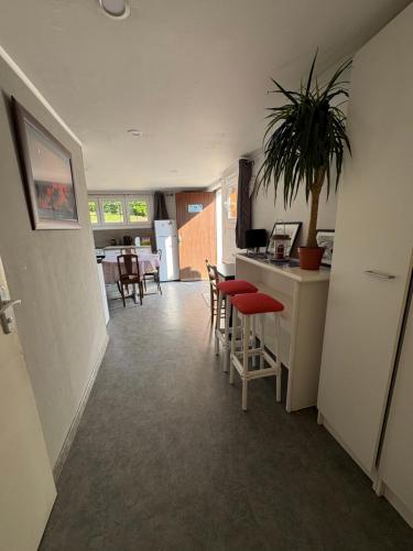 a kitchen and dining room with a table and chairs at GLAM in Saint-Jean-dʼArvey