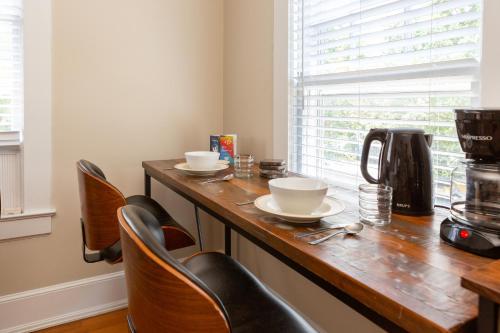 a kitchen with a wooden counter top with chairs at Sunny efficiency in historic home in Durham