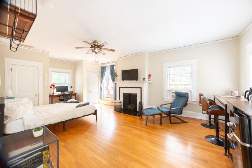 a living room with a couch and a fireplace at Sunny efficiency in historic home in Durham
