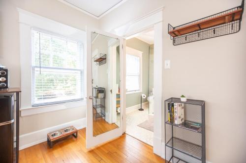 a hallway with a door leading into a room at Sunny Efficiency In Historic Home in Durham