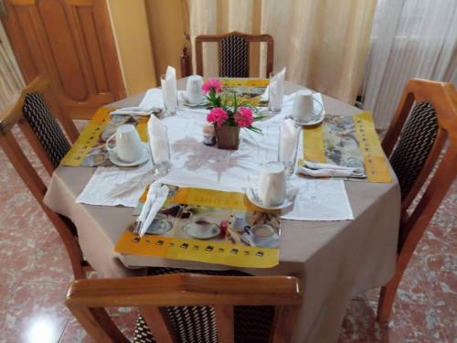 a dining room table with a yellow and white table cloth at Heritage Hotel in Trofwi