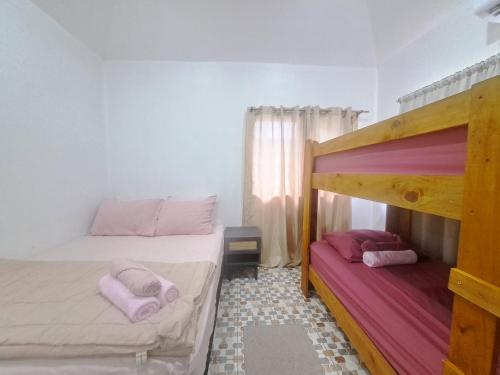 a bedroom with two bunk beds with pink pillows at Big Family Space - 3 AC Bedrooms in Apia