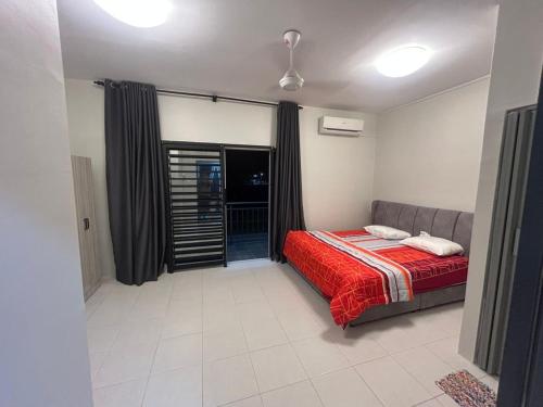 ein Schlafzimmer mit einem Bett mit einer roten Decke in der Unterkunft Daus&iqah Homestay Jasin Mlk in Merlimau