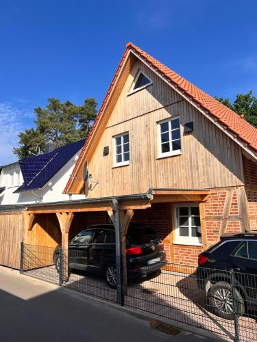 a house with a car parked in the garage at Fachwerkhuus in Göhren-Lebbin