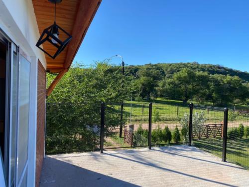 a porch with a fence and a view of a field at El Rincon de las Marias in San Lorenzo