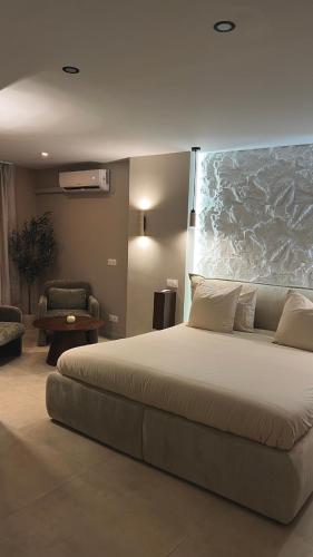 a bedroom with a large bed and a chair at L instant précieux in Marseille