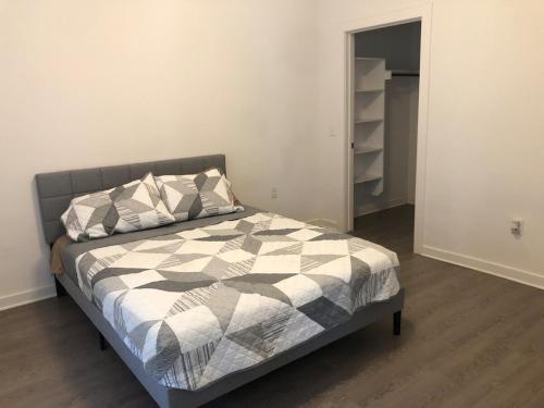 a bedroom with a bed with a black and white comforter at Modern Leander Getaway Near Shop- Leander TX in Leander