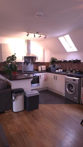 a kitchen with a sink and a stove top oven at Modern Beautiful Luxury Coach House Free Parking in Birmingham