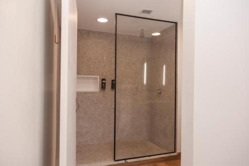 a shower with a glass door in a bathroom at ibis Catanduva in Catanduva