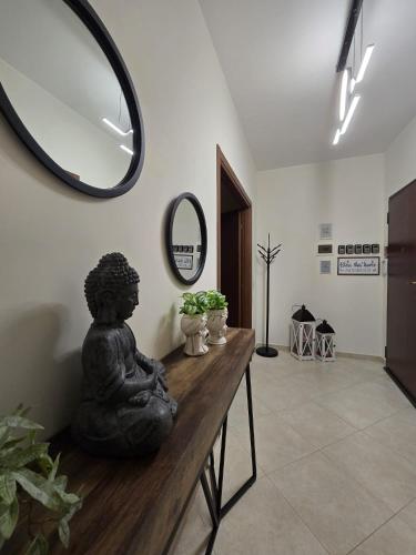 a statue sitting on a table in a room with a mirror at CJ SEA HOME CAMERE in Trapani