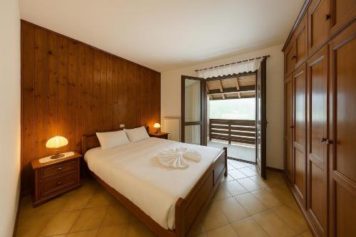 a bedroom with a large bed and a window at Walk to Slopes & Free Parking -Capriolo Tarvisio in Tarvisio