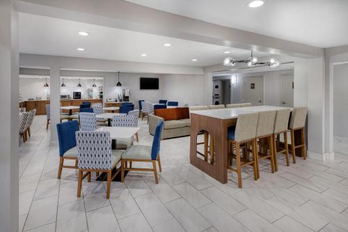 Best Western Greensboro Coliseum Inn في جرينسبورو: غرفة طعام وغرفة معيشة مع طاولة وكراسي