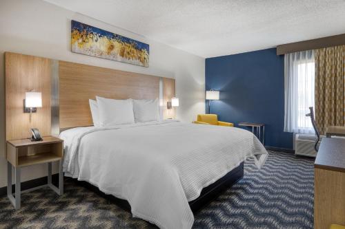 a hotel room with a large bed and a window at Best Western Greensboro Coliseum Inn in Greensboro