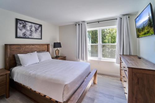 a bedroom with a bed and a large window at The Ruby 314 By Avada Properties in Pigeon Forge