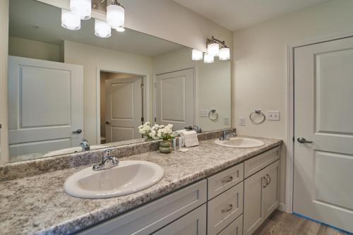 a bathroom with two sinks and a large mirror at The Ruby 314 By Avada Properties in Pigeon Forge