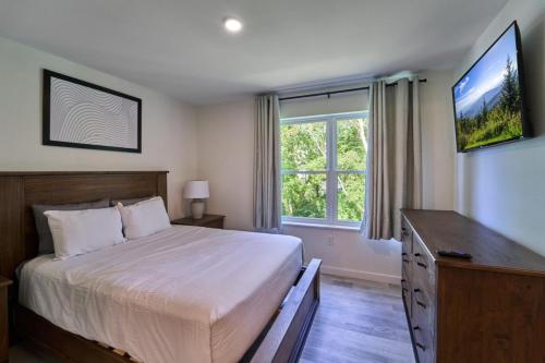 a bedroom with a bed and a large window at The Ruby 315 By Avada Properties in Pigeon Forge