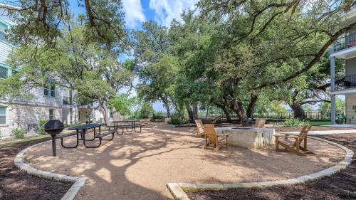a park with benches and a table and trees at New 1BR Apt leander tx in Leander