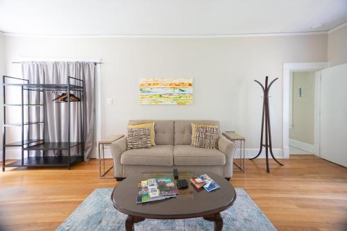 a living room with a couch and a table at Spacious 2BR in Grand Old Home, Downtown Durham in Durham