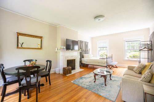a living room with a table and a fireplace at Spacious 2BR in Grand Old Home, Downtown Durham in Durham