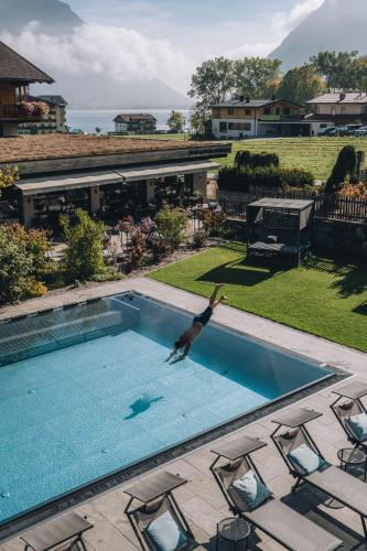 a bird is jumping into a swimming pool at Hotel Wagnerhof in Pertisau