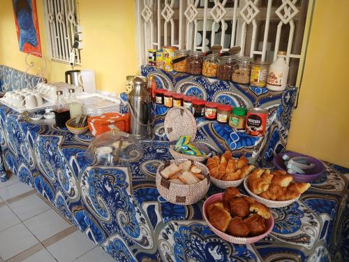 a table with baskets of bread and other foods on it at Auberge Triskell in Nouakchott