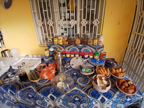 a blue and white table topped with dishes and food at Auberge Triskell in Nouakchott