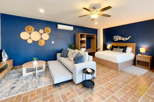 a living room with a couch and a bed at Beachfront Compound, Pool, BBQ, Best for Groups in Refugio