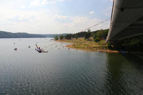 a person in the water on a rope in a lake at Cyklochata in Vranov nad Dyjí