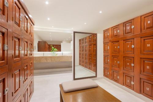 a locker room with wooden doors and a mirror at Royal Solaris Cancun - All Inclusive in Cancún