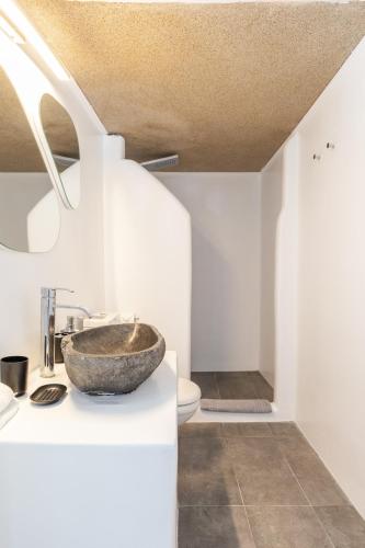 a bathroom with a bowl sink on a counter at Mykonian Breeze in Ano Mera