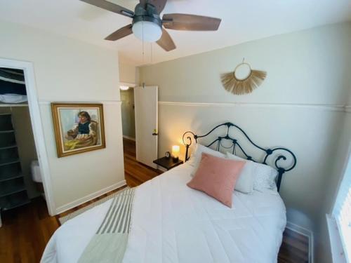 a bedroom with a bed and a ceiling fan at Midtown Cottage- Walk to Whole Foods in Tallahassee