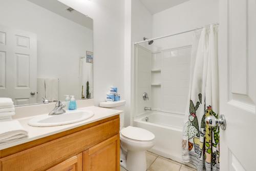 a white bathroom with a toilet and a sink at Quiet and Convenient! Santa Rosa Family Home with Yard in Fulton