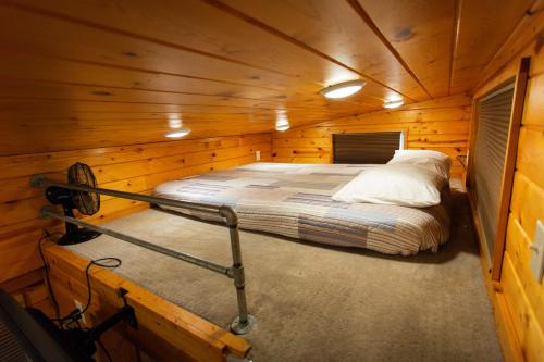 a bedroom in a wooden cabin with a bed in it at JW Grand Junction in Grand Junction